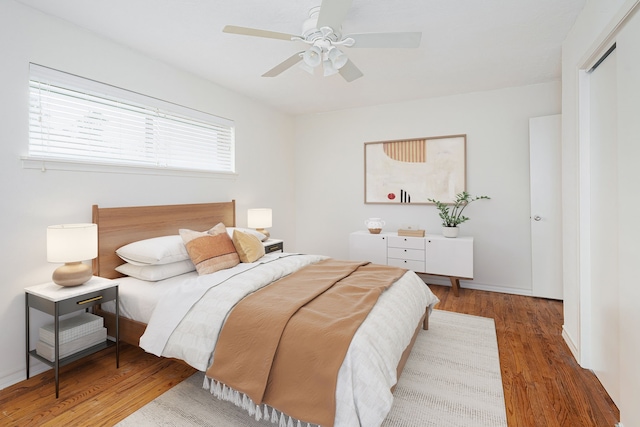 bedroom with a closet, ceiling fan, and hardwood / wood-style floors