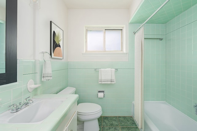 full bathroom featuring toilet, shower / tub combo, tile walls, tile patterned flooring, and vanity