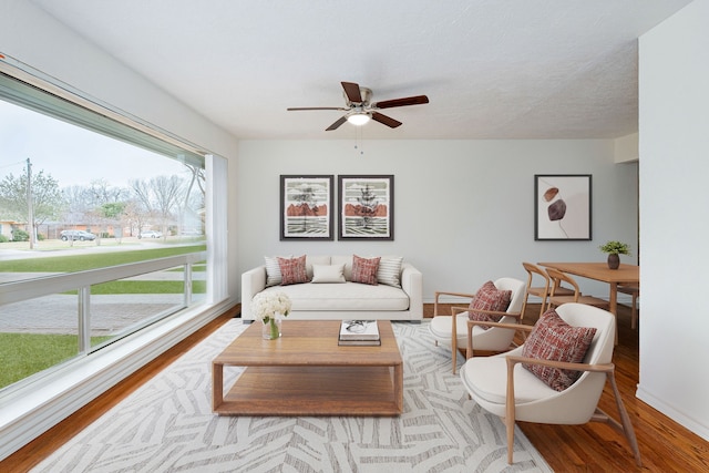 living room with hardwood / wood-style flooring and ceiling fan