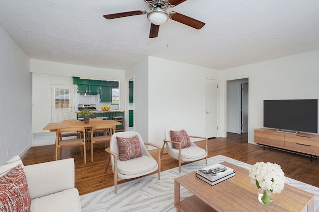 living room featuring ceiling fan and wood-type flooring