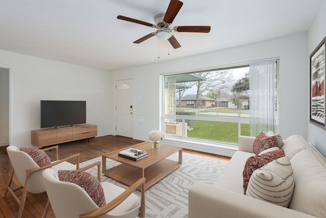 living room featuring wood-type flooring and ceiling fan