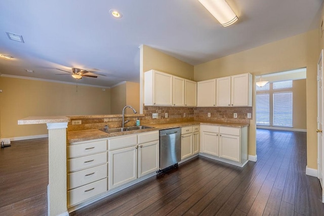 kitchen featuring sink, dishwasher, kitchen peninsula, and white cabinets