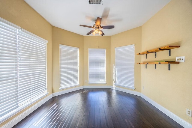 unfurnished room featuring dark hardwood / wood-style flooring and ceiling fan