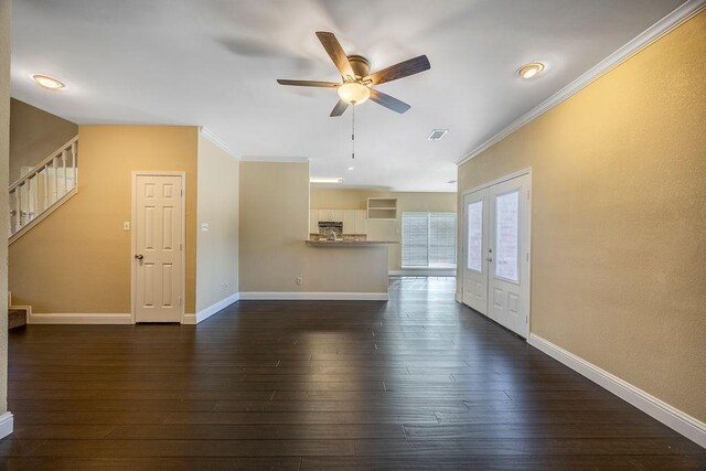 unfurnished living room featuring crown molding, dark wood-type flooring, ceiling fan, and french doors