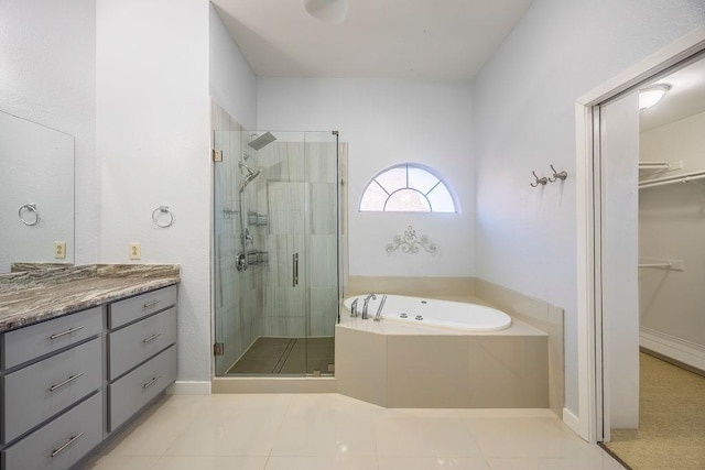 bathroom featuring tile patterned floors, separate shower and tub, and vanity