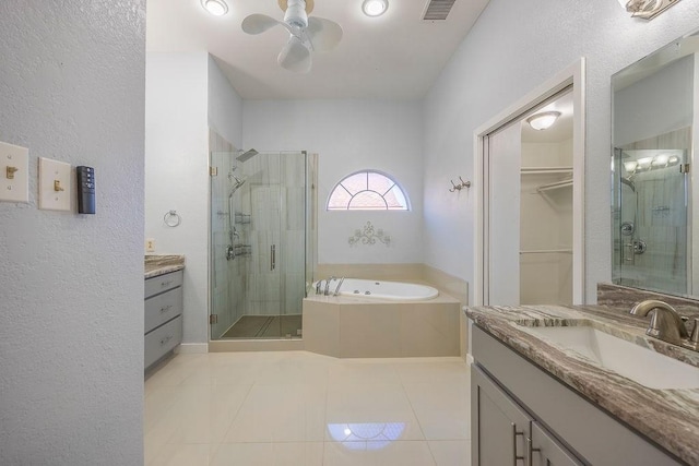 bathroom featuring ceiling fan, vanity, shower with separate bathtub, and tile patterned flooring