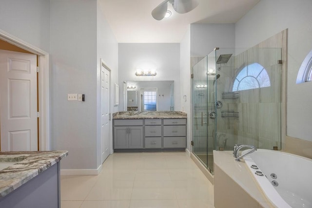 bathroom with tile patterned floors, vanity, and plus walk in shower