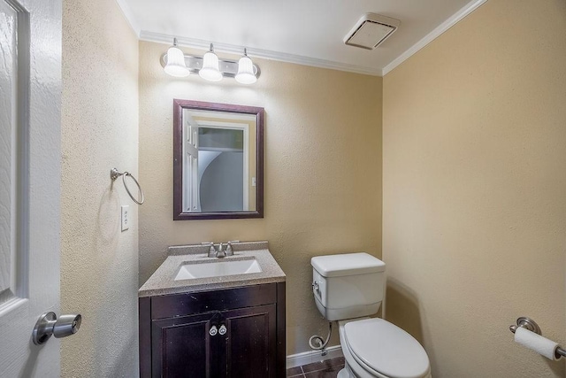 bathroom featuring vanity, crown molding, and toilet