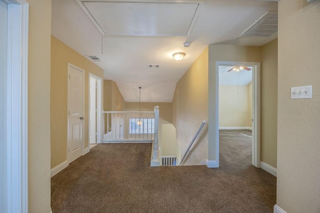 hall with carpet and lofted ceiling