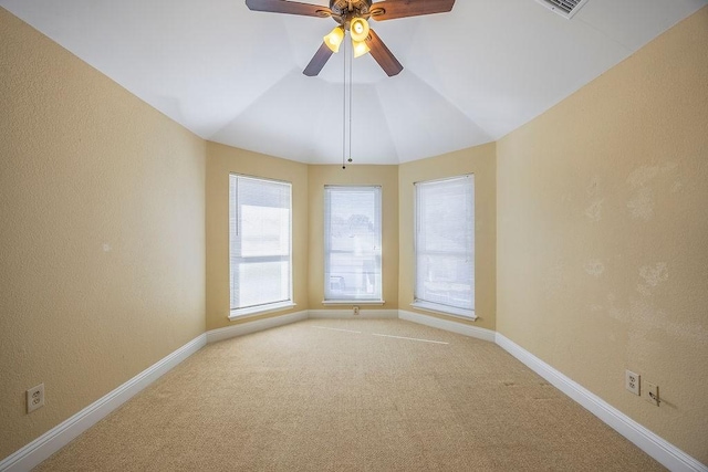 unfurnished room featuring lofted ceiling, carpet floors, and ceiling fan