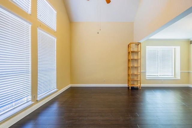 spare room with ceiling fan, lofted ceiling, and dark hardwood / wood-style flooring