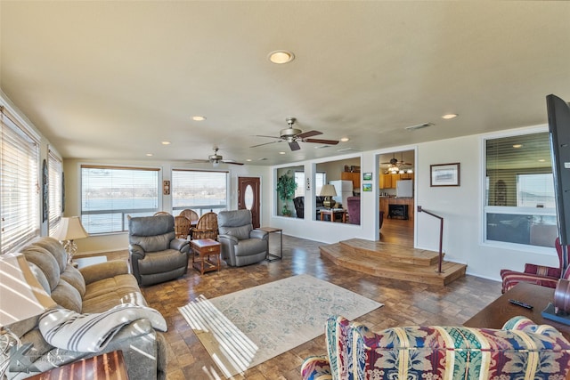 living area with ceiling fan, baseboards, visible vents, and recessed lighting