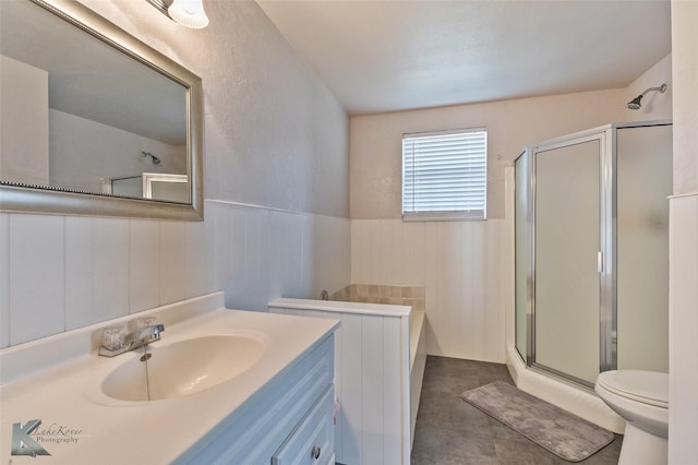 full bathroom with wainscoting, vanity, a shower stall, and toilet