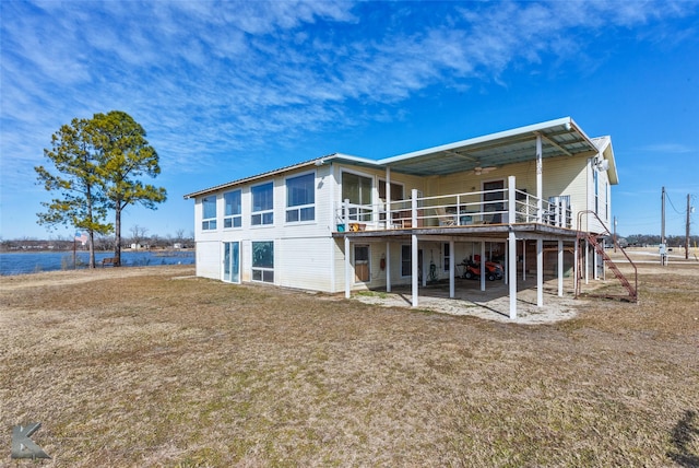 rear view of house featuring a deck and a yard