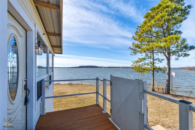 wooden deck featuring a water view