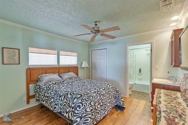 206 County Road 541, Eastland, TX 76448 - bedroom with visible vents, a closet, crown molding, a textured ceiling, and ceiling fan