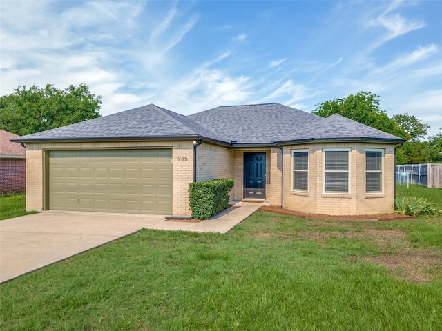 view of front of home with a garage and a front lawn