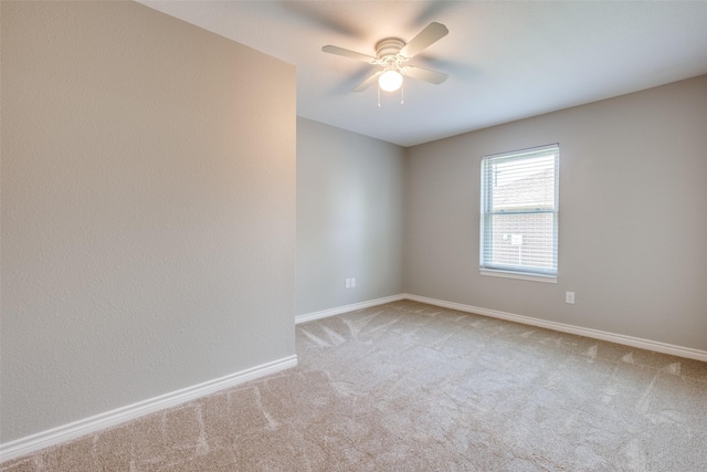 unfurnished room with ceiling fan and light carpet