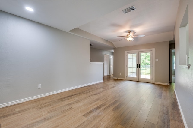 spare room featuring light hardwood / wood-style floors, ceiling fan, and french doors