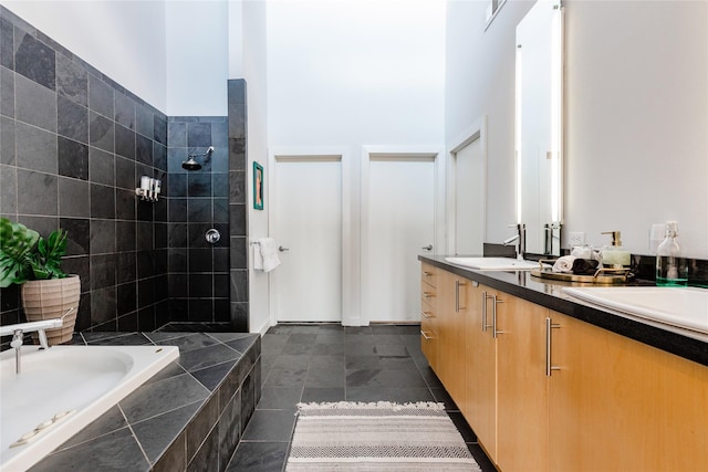 bathroom featuring plus walk in shower, tile patterned floors, and vanity