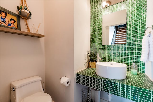 bathroom with backsplash and toilet