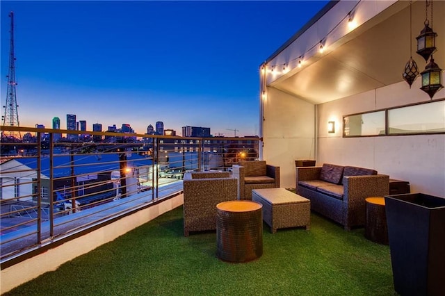 balcony at dusk featuring an outdoor hangout area