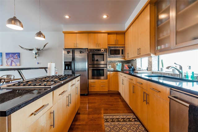 kitchen featuring dark hardwood / wood-style flooring, sink, decorative light fixtures, decorative backsplash, and stainless steel appliances