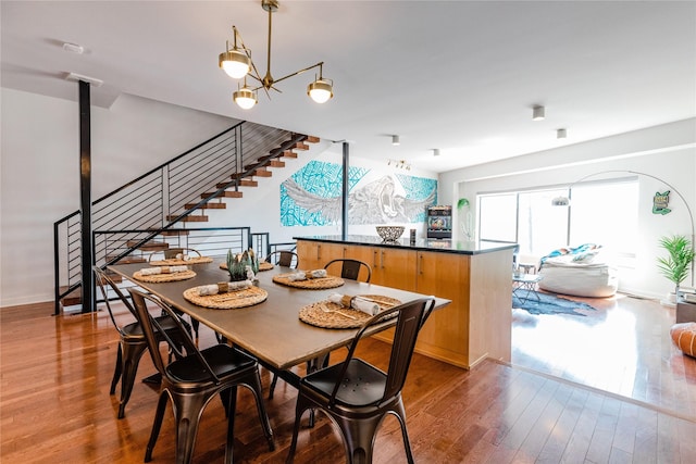 dining room featuring wood-type flooring and a chandelier