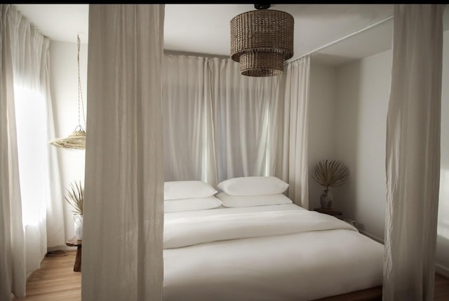 bedroom featuring light hardwood / wood-style flooring and a notable chandelier