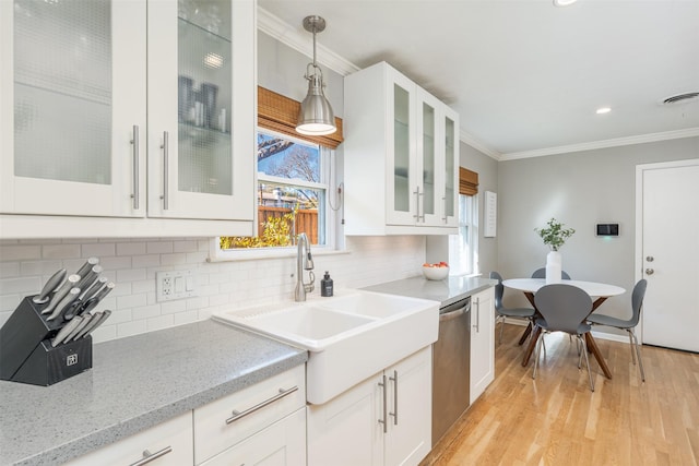 kitchen with stainless steel dishwasher, hanging light fixtures, white cabinetry, ornamental molding, and decorative backsplash