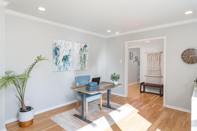 home office with ornamental molding and light hardwood / wood-style floors