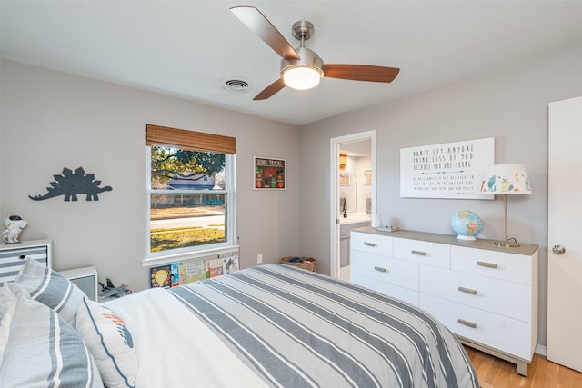 bedroom with ceiling fan, light hardwood / wood-style flooring, and ensuite bath