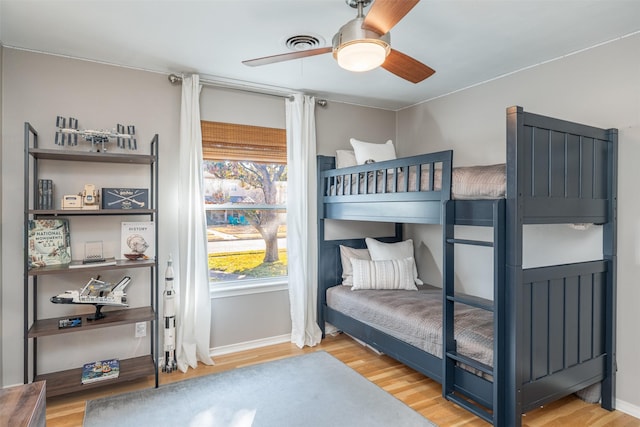 bedroom with ceiling fan and hardwood / wood-style flooring