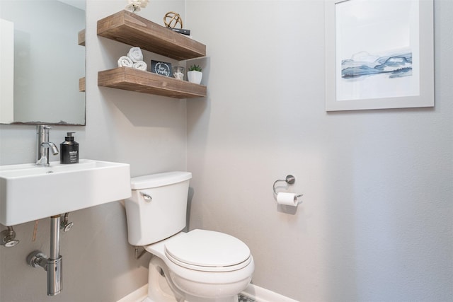 bathroom featuring sink and toilet