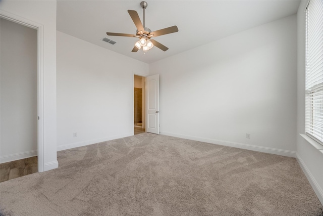 carpeted spare room with ceiling fan