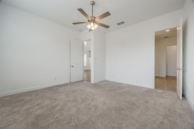 unfurnished bedroom featuring ceiling fan and light carpet