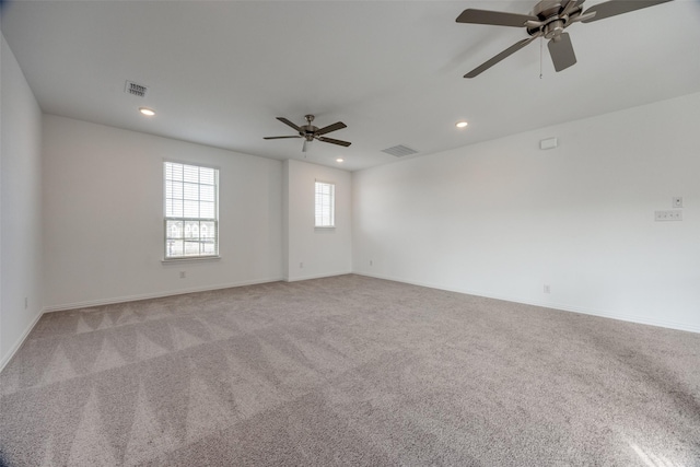 spare room with ceiling fan and light colored carpet