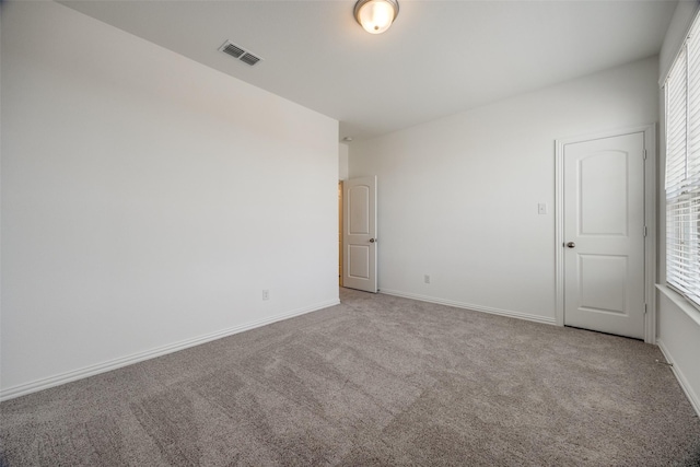 unfurnished room with light colored carpet