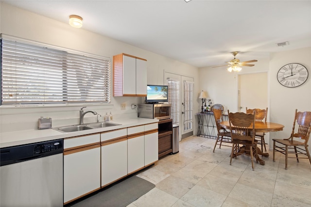 kitchen featuring white cabinets, stainless steel appliances, ceiling fan, and sink