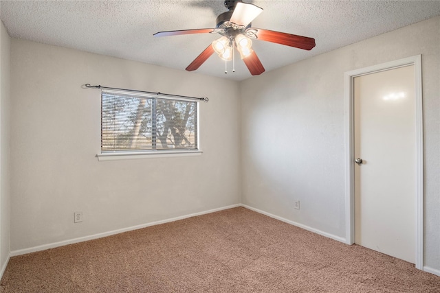 carpeted empty room with a textured ceiling and ceiling fan