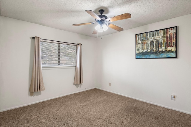 carpeted spare room featuring ceiling fan and a textured ceiling