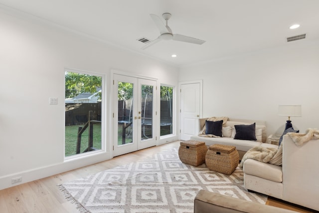 living room featuring light hardwood / wood-style floors, french doors, and ceiling fan