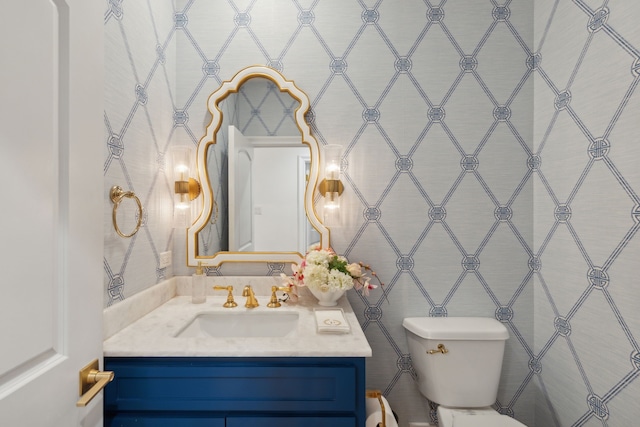 bathroom with vanity, tile walls, and toilet