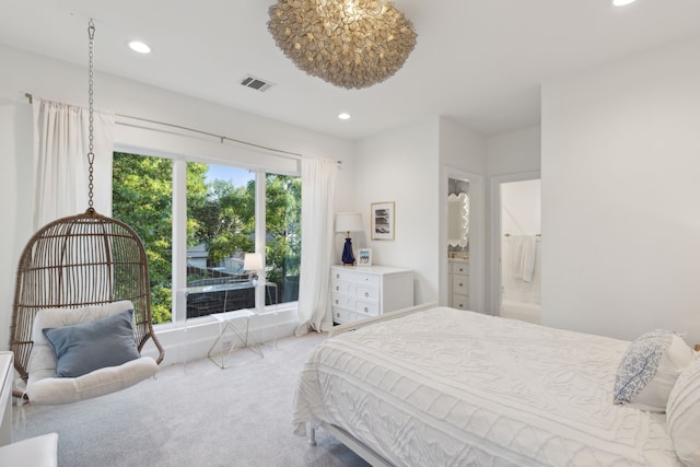 bedroom with ensuite bathroom and carpet