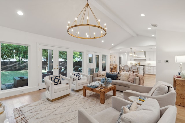 living room with an inviting chandelier, lofted ceiling with beams, light hardwood / wood-style flooring, and french doors