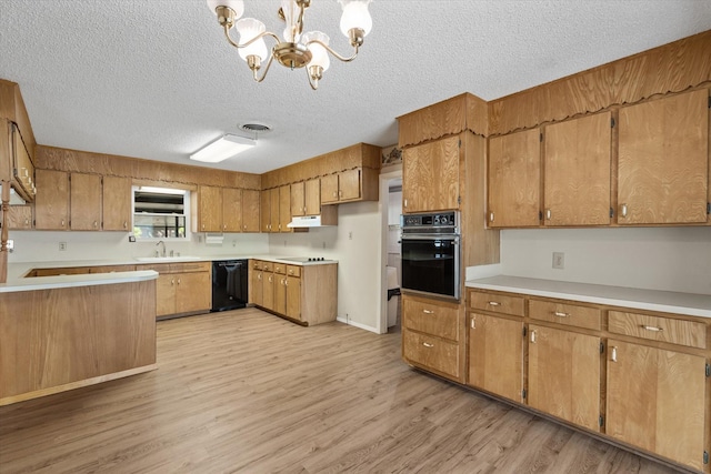 kitchen featuring an inviting chandelier, hanging light fixtures, black appliances, a textured ceiling, and light wood-type flooring