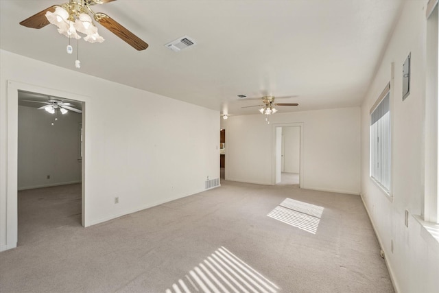 unfurnished room featuring light carpet