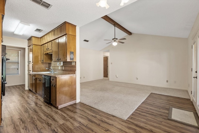 kitchen featuring lofted ceiling with beams, black dishwasher, dark hardwood / wood-style flooring, ceiling fan, and a textured ceiling