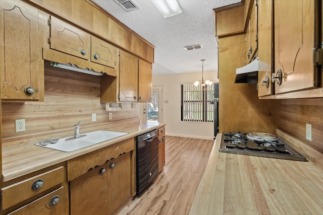 kitchen featuring sink, light hardwood / wood-style flooring, dishwasher, hanging light fixtures, and stainless steel gas cooktop