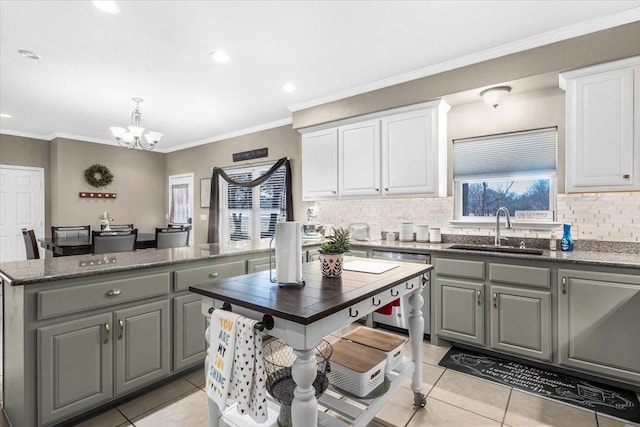 kitchen with sink, white cabinets, a kitchen island, and light tile patterned flooring